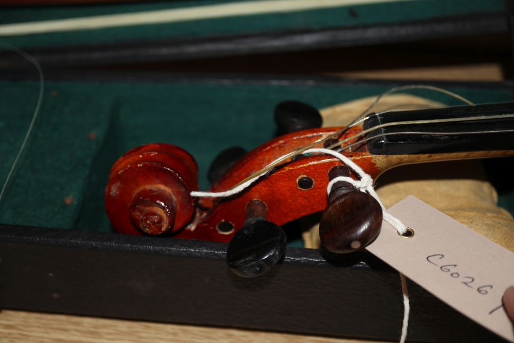 A 20th century Antonius Stradivarius Cremonensis violin, cased with two bows